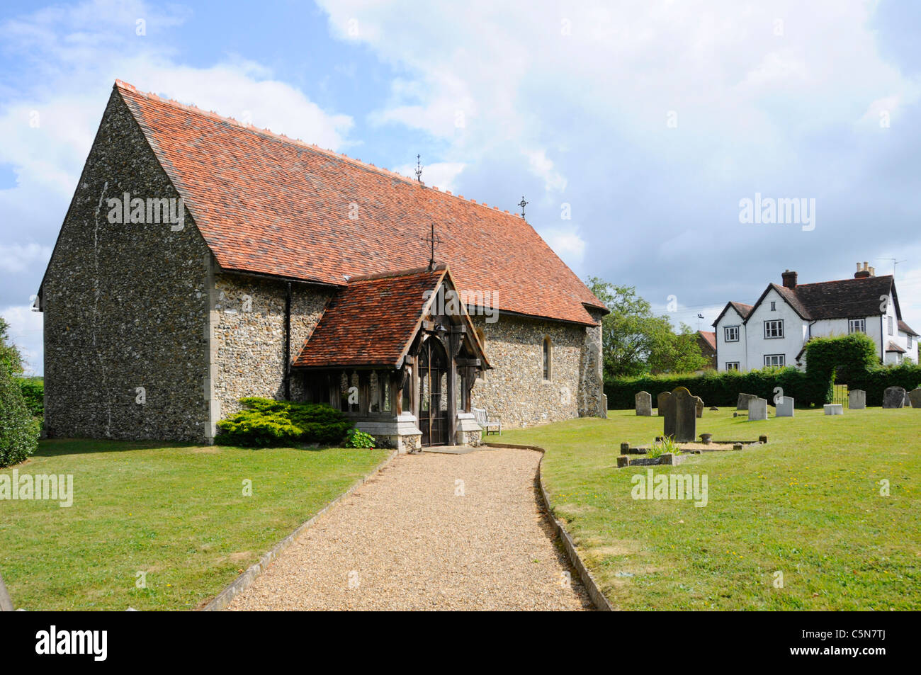 14th century Grade II listed St Mary the Virgin Church rectangular shape of Flint rubble walls roof red plain tiles & graveyard at Little Laver Essex Stock Photo