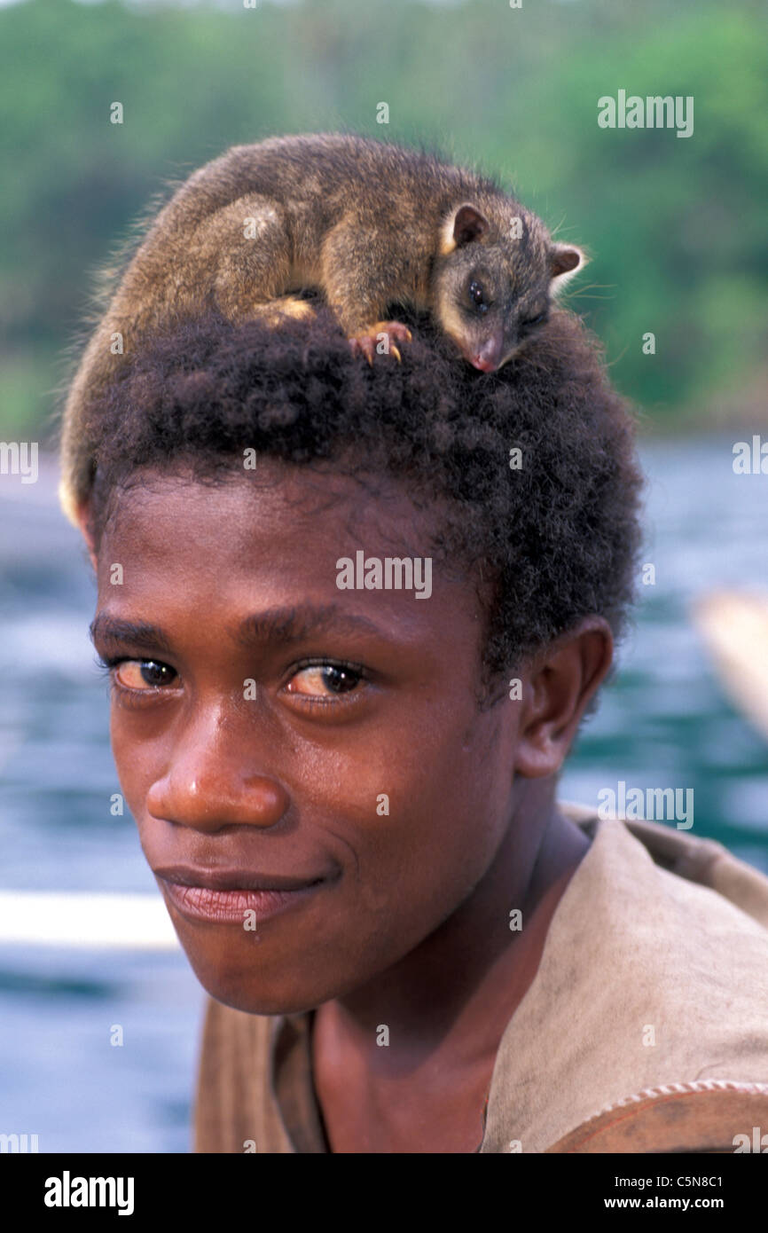 Young Man carry Marsupial on his Head, Vitu Islands, Bismarck Archipelago, Papua New Guinea Stock Photo