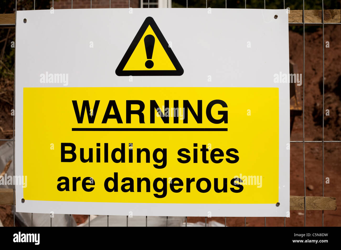 A Warning building sites are dangerous sign at a building site Nottingham England UK Stock Photo