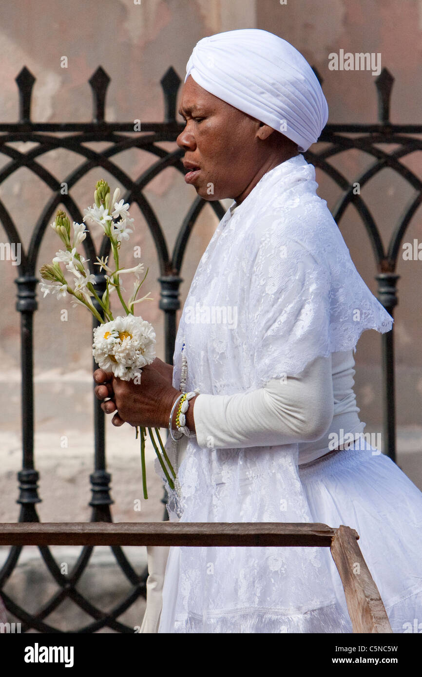 Cuba, Havana. Woman Practitioner of Santeria entering Church of La Merced. Stock Photo