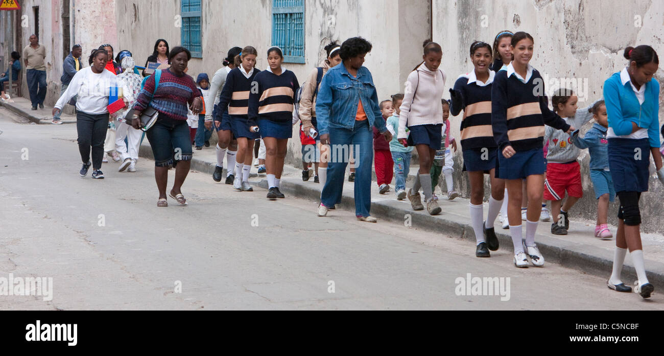Cuba, Havana. Young Women and School Children Walking. Stock Photo