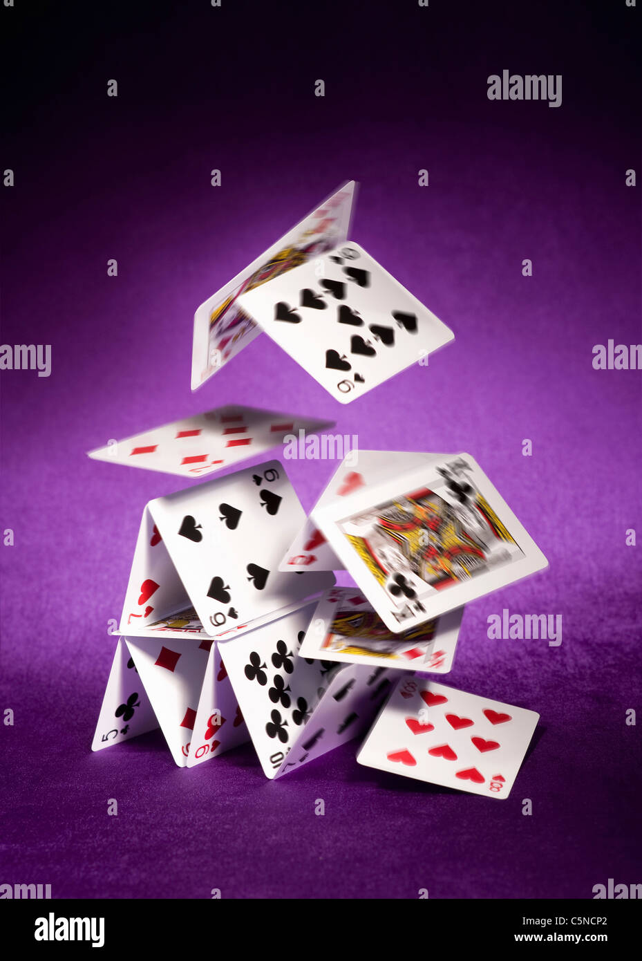 A house of cards falling down Stock Photo