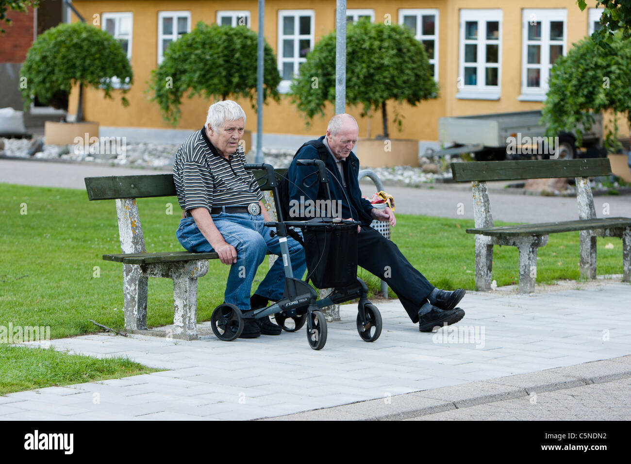 Two elderly men sitting on a bench Stock Photo - Alamy