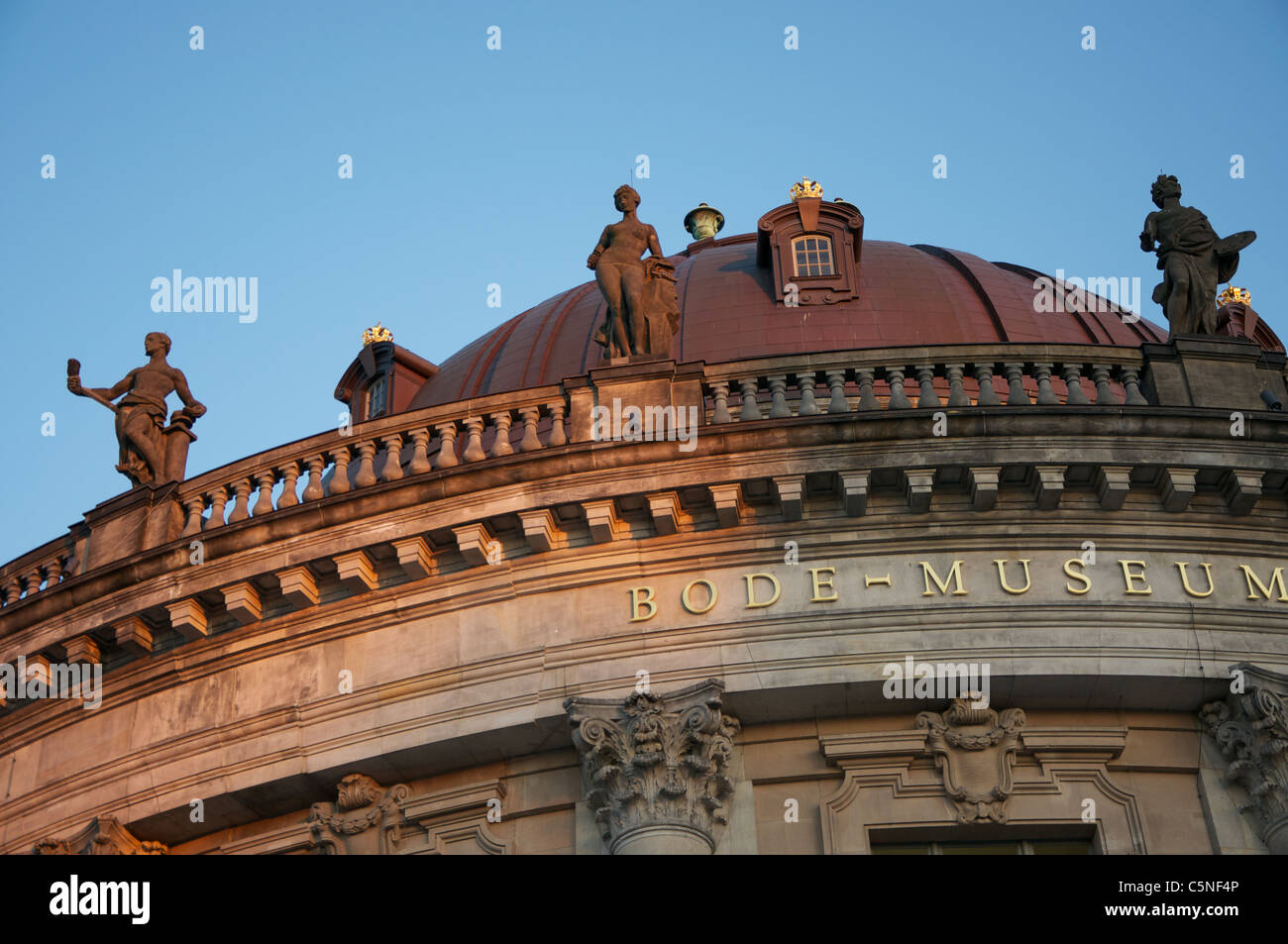 Dome of the Bode Museum Berlin with statues against a blue sky Stock Photo