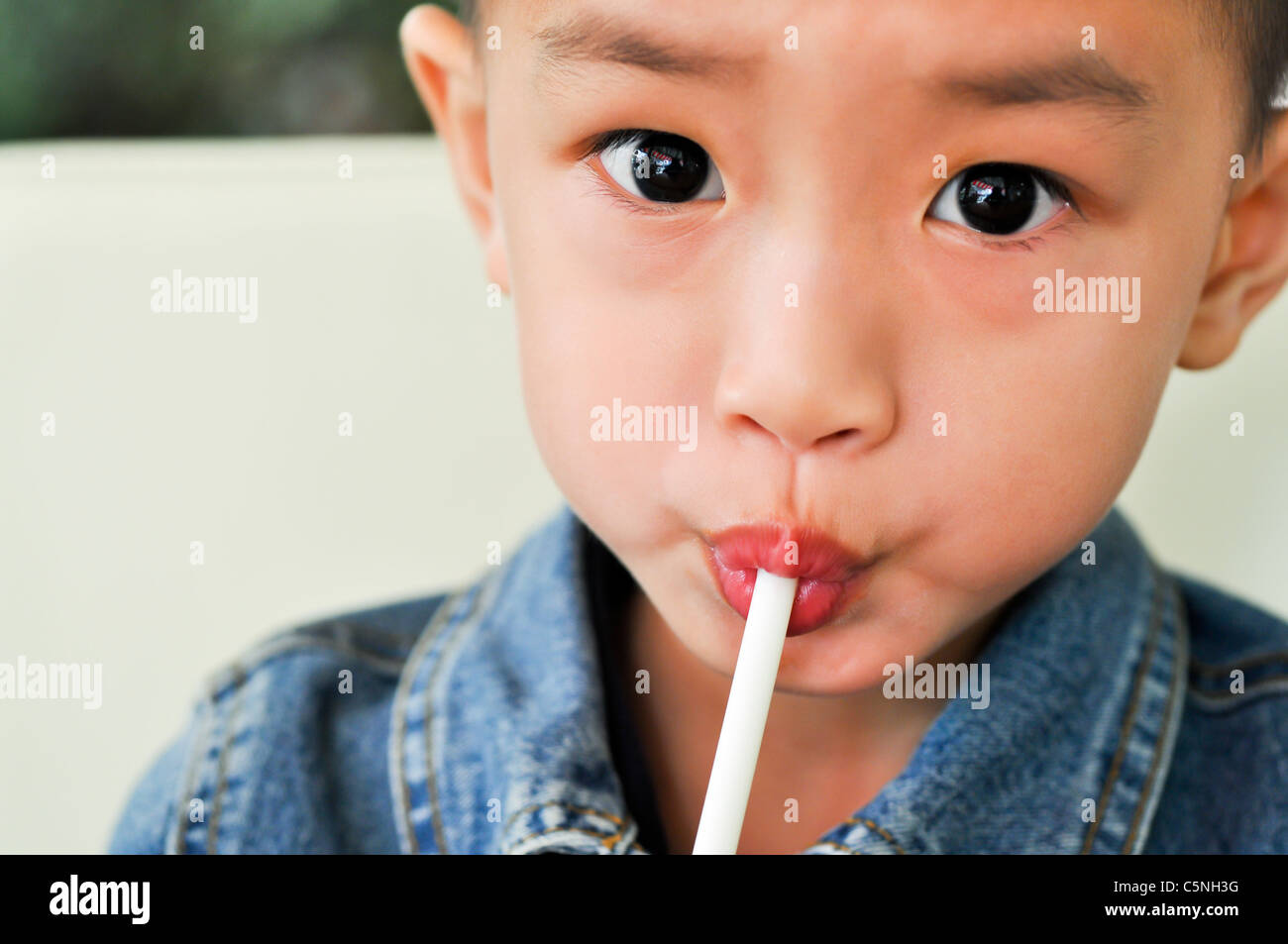 The boy with the straw Stock Photo