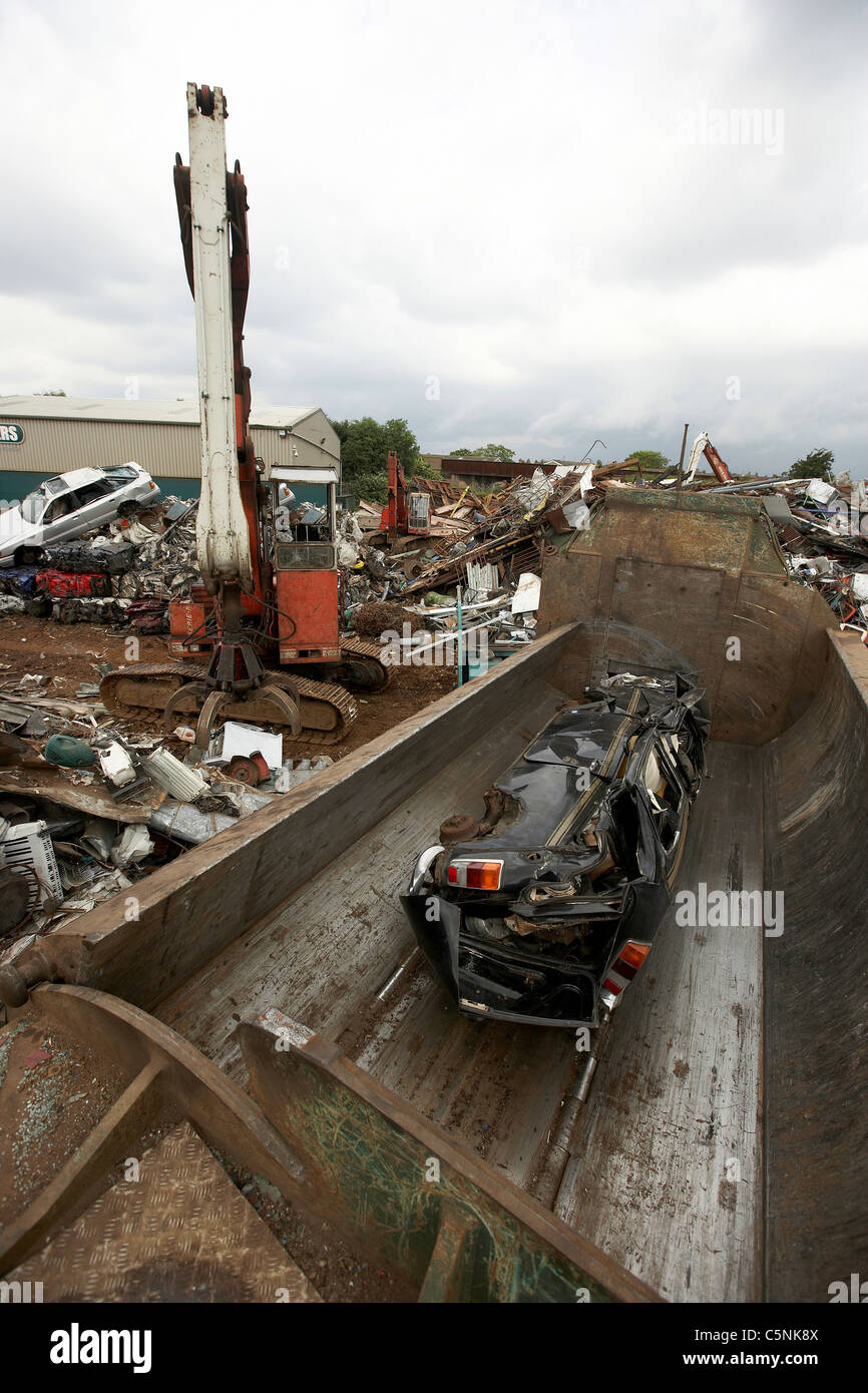 Scrap car crushed in a metal crusher ready for recycling in a scrapyard