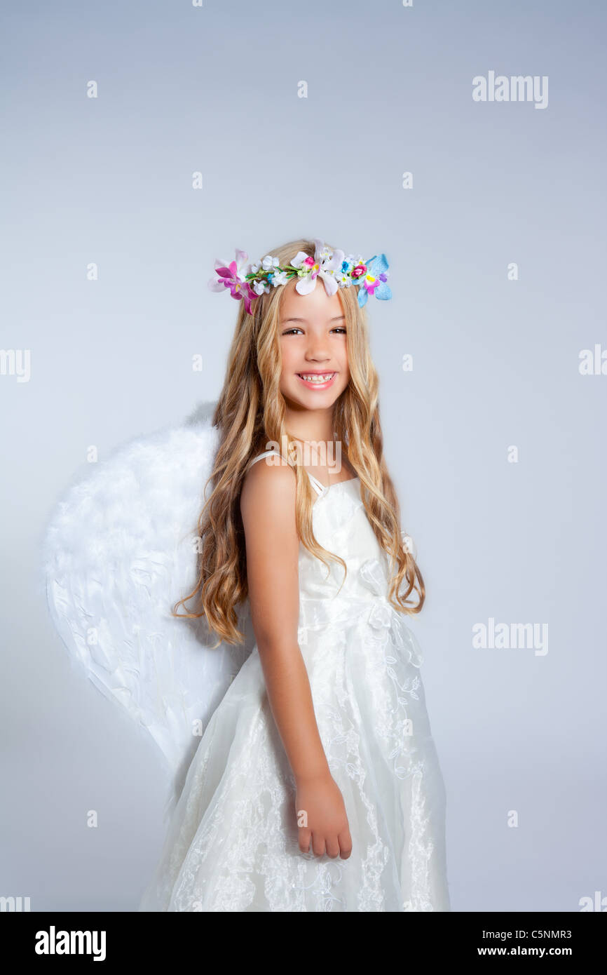 Angel children little girl portrait with fashion white wings and flowers crown Stock Photo