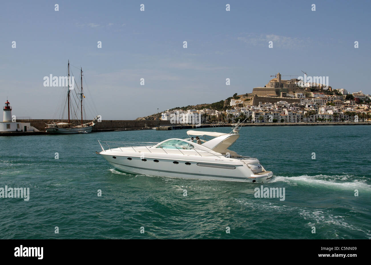 Luxury Fairline motoryacht departing the harbour at Eivissa Ibiza a Spanish Island in the Mediterranean Sea Stock Photo