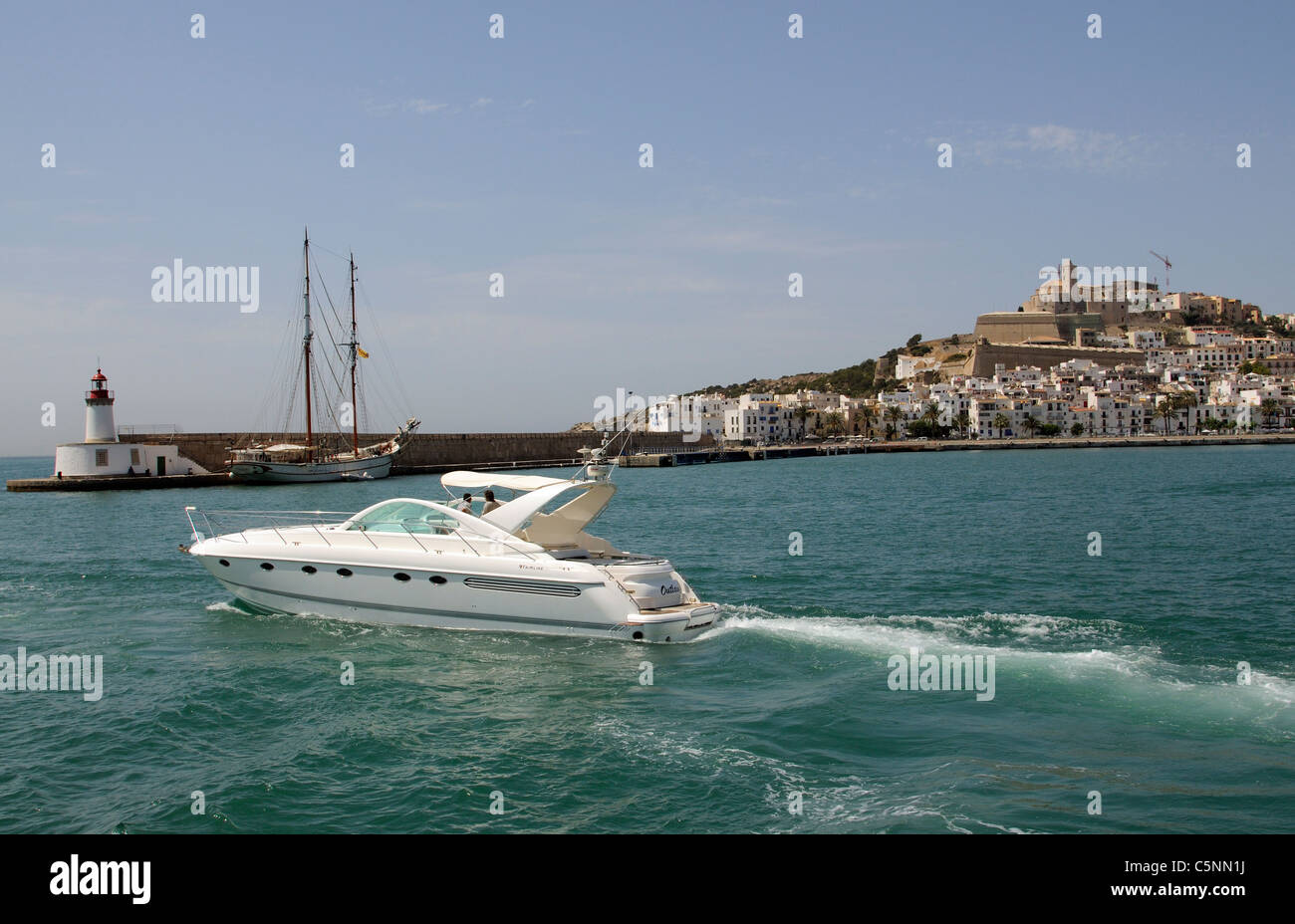 Luxury Fairline motoryacht departing the harbour at Eivissa Ibiza a Spanish Island in the Mediterranean Sea Stock Photo