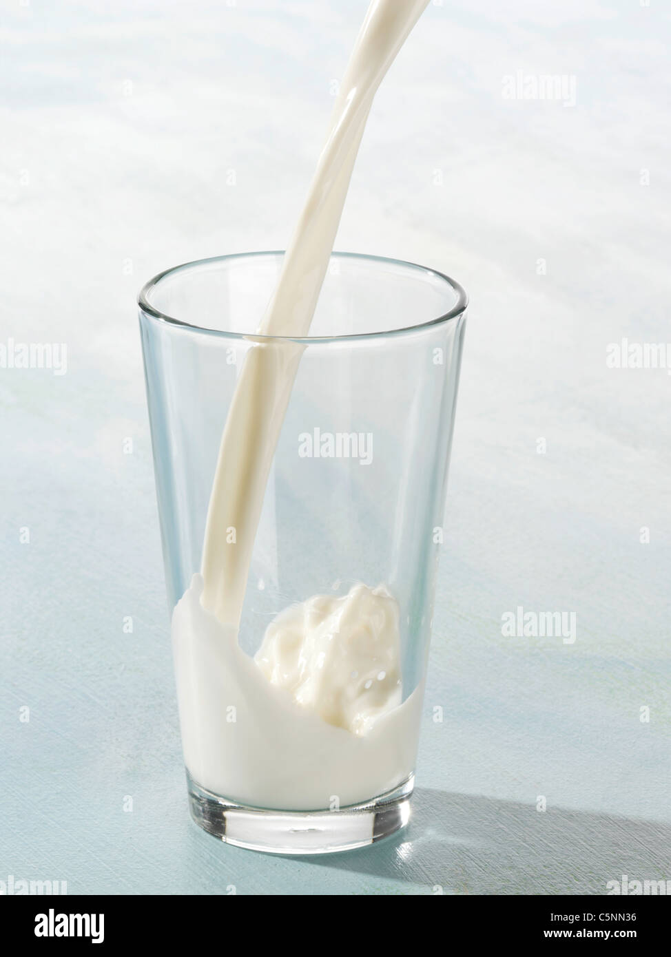 Milk being poured into a glass Stock Photo Alamy