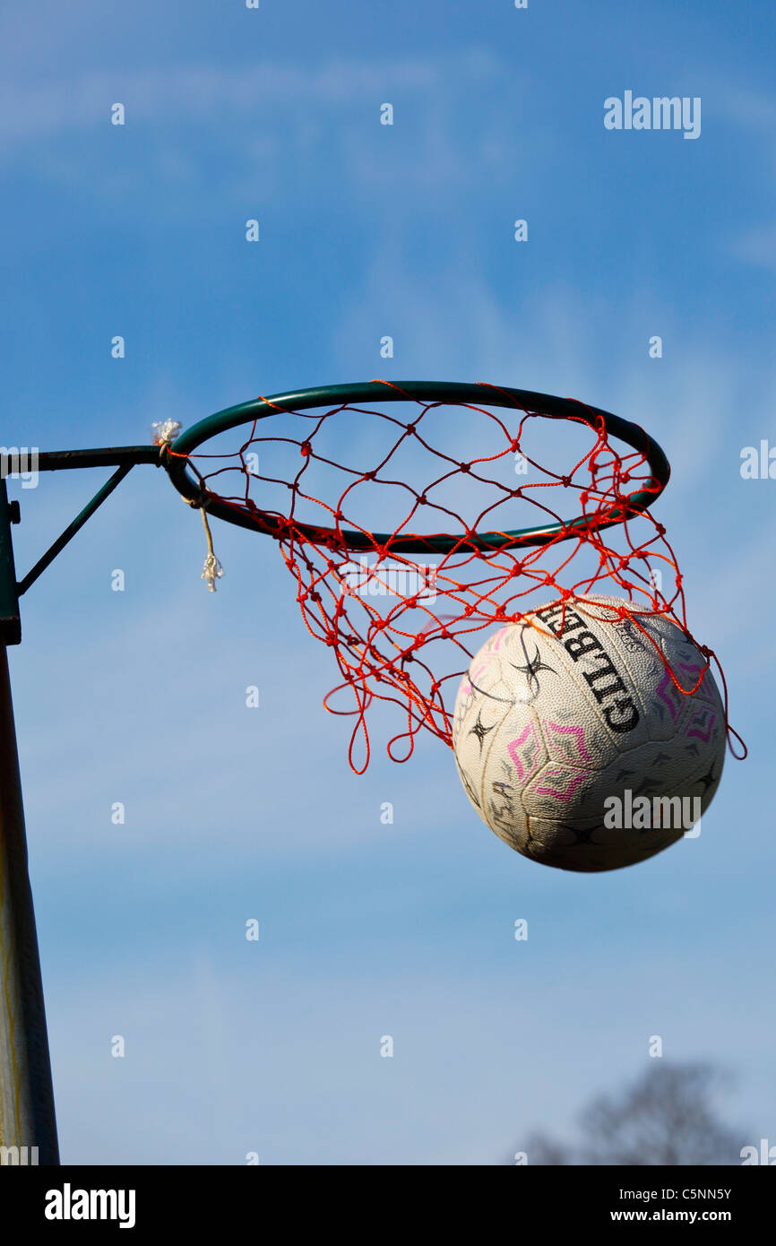 The Gilbert netball goes into the ring for a goal during a girls netball tournament Stock Photo