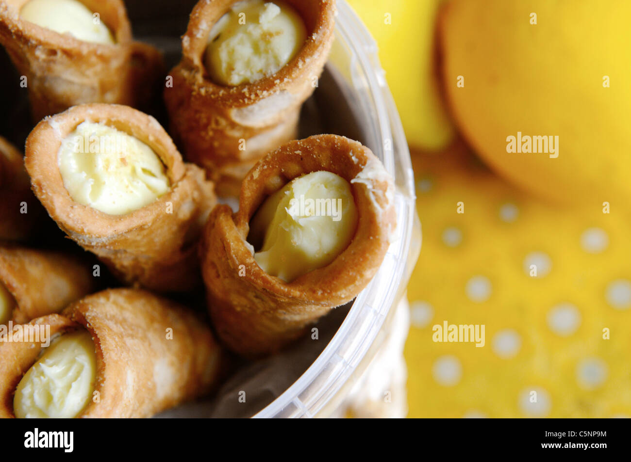 Italian cookie rolls with lemon stuffing (Cannoli) Stock Photo