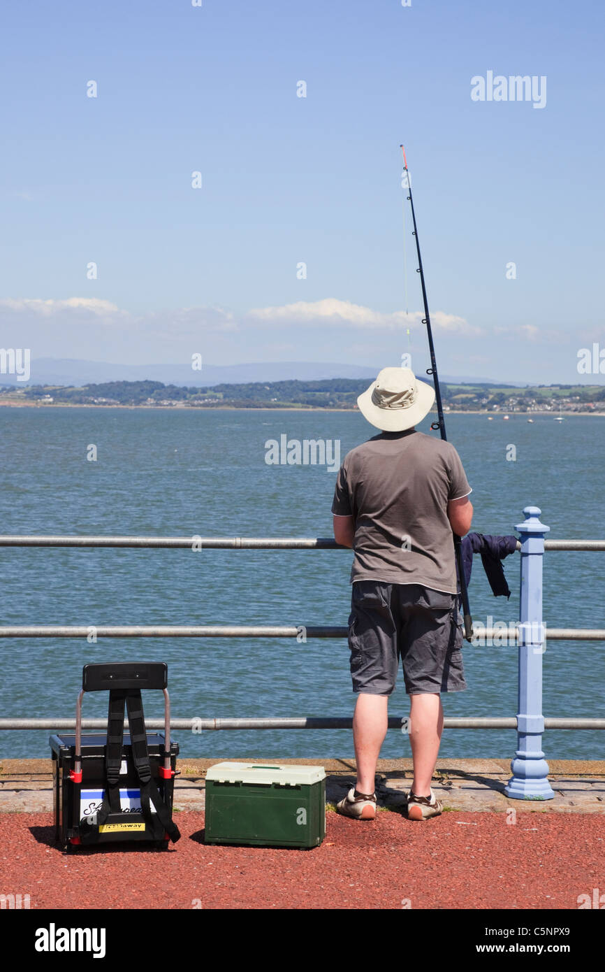 Sea fishing tackle, rods, reels leaning against railing on side of pier  Stock Photo - Alamy