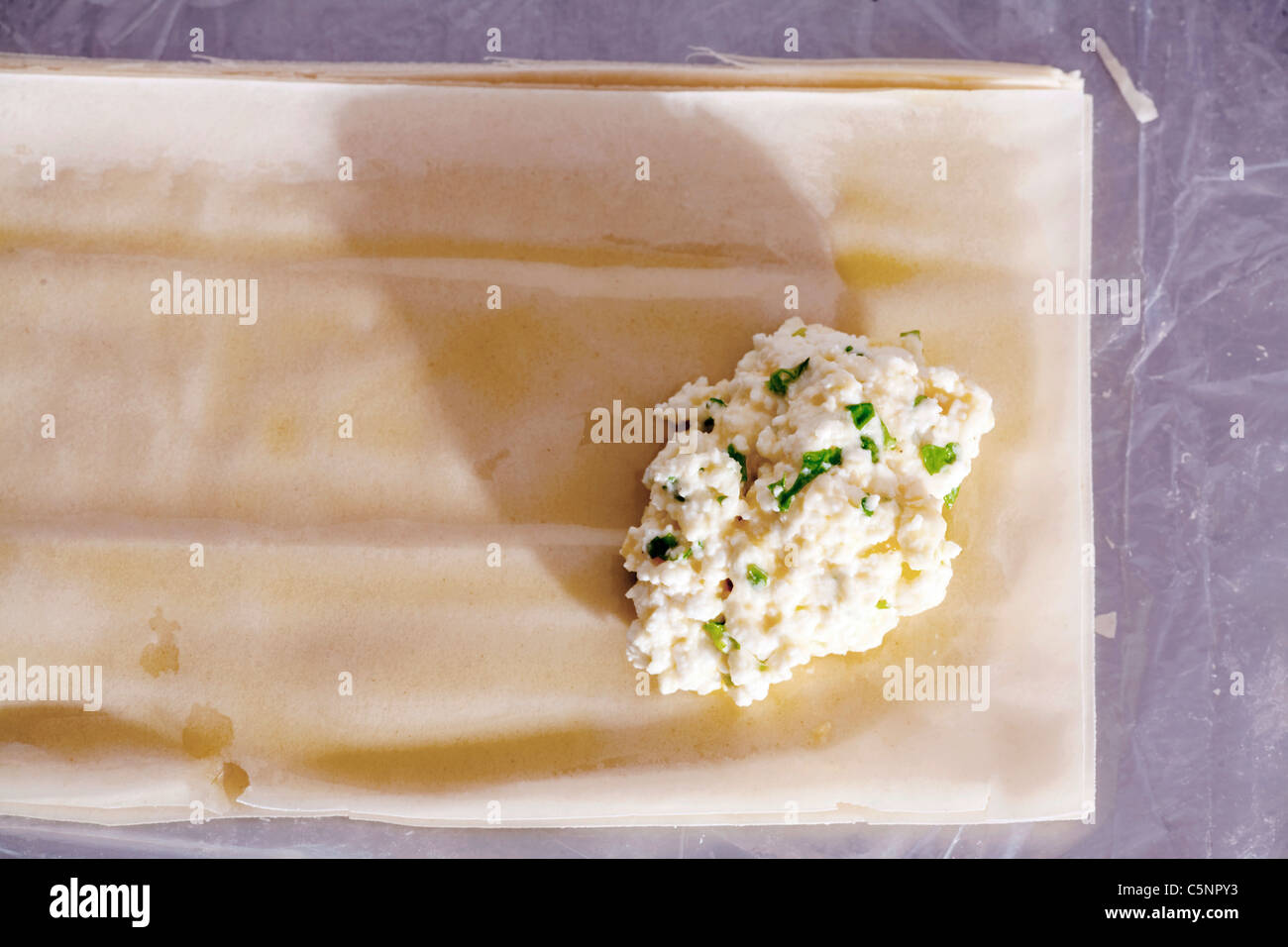 Stuffing filo pastry with feta, egg and parsley Stock Photo Alamy