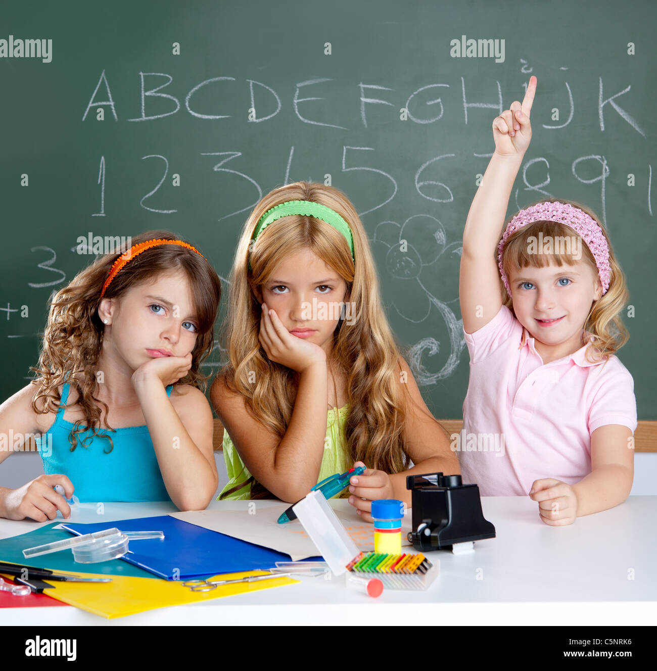 boring sad student with clever children girl raising hand finger at Stock Photo ...