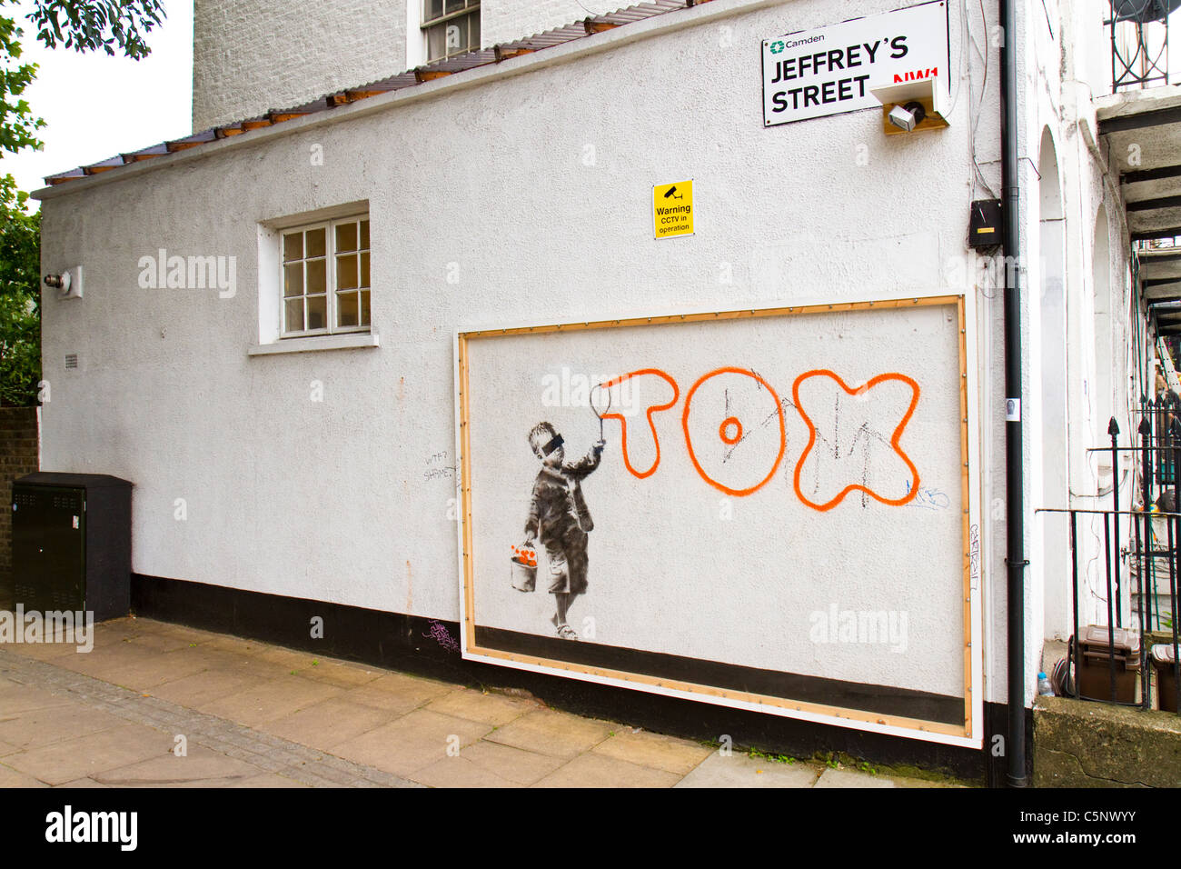 Graffiti art by street artist Banksy which mentions another graffiti writer, Tox, on a wall in Camden Town, London, UK. Stock Photo