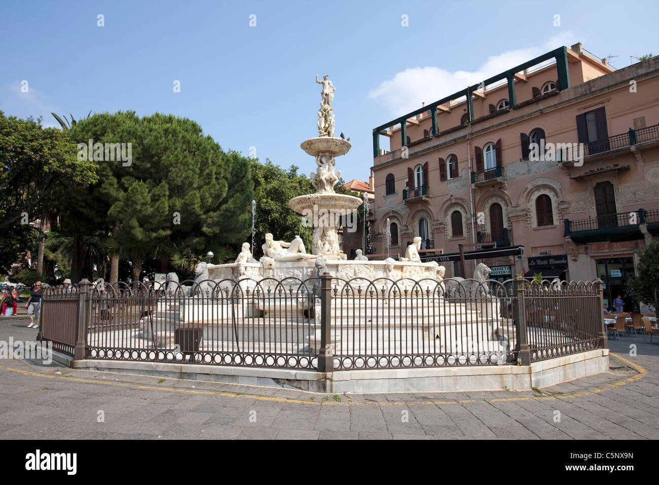 Messina Sicily Italy Orion Fountain in public square of the Cathedral. Open air shops and restaurants in background. Don Despain Stock Photo
