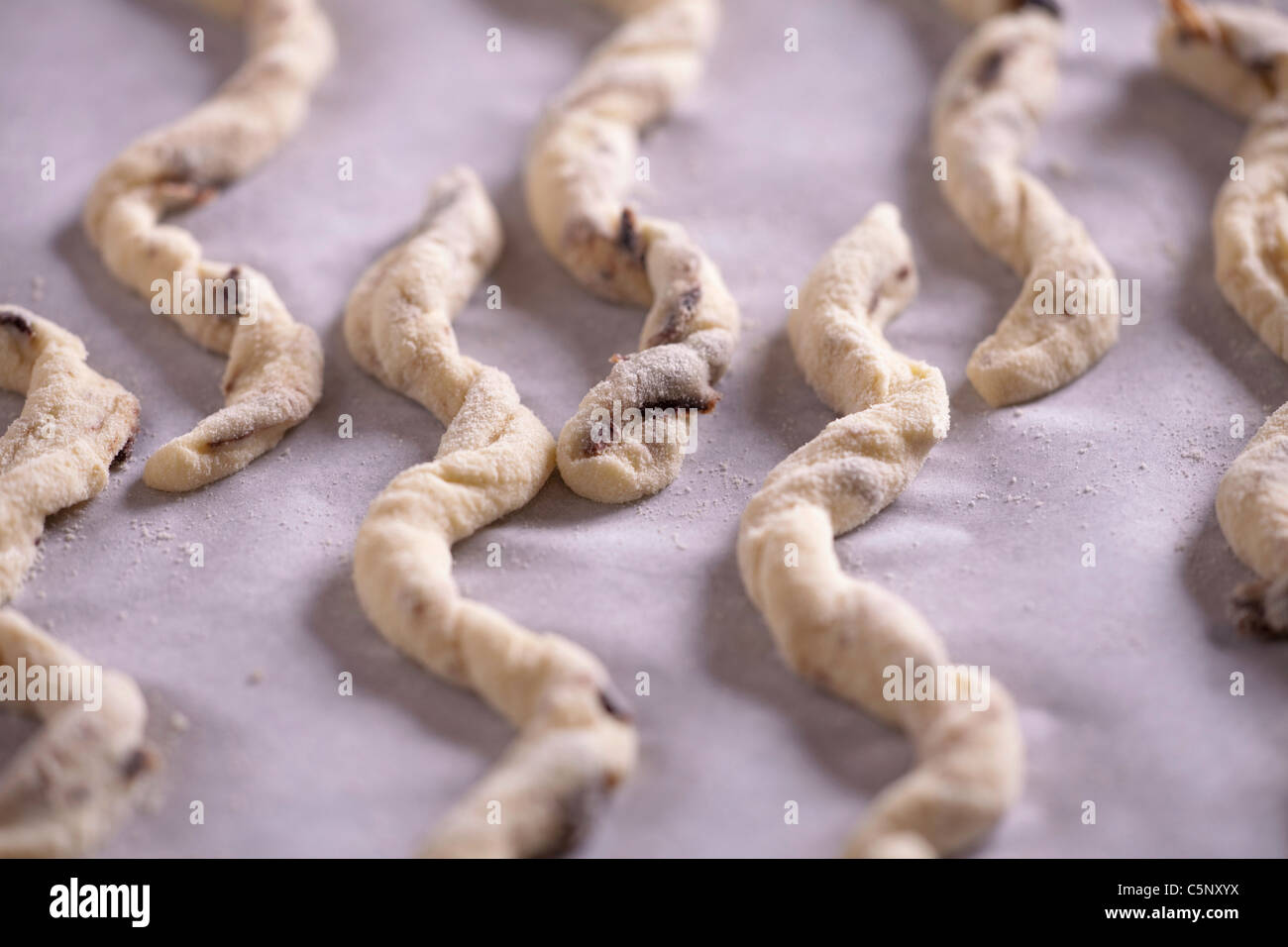 Raw grissini (bread sticks) with black olives Stock Photo