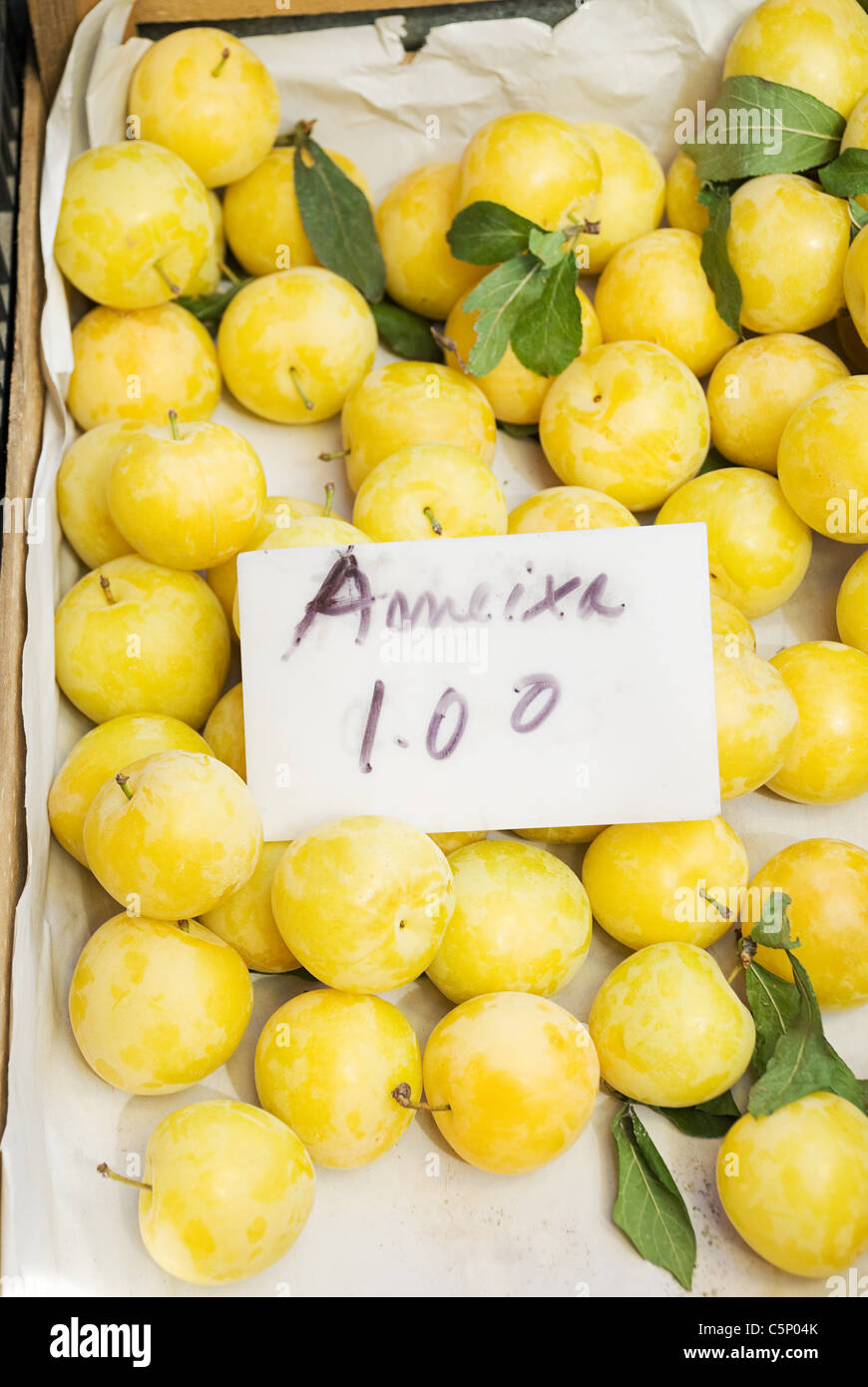 Plums on fruit stall Stock Photo