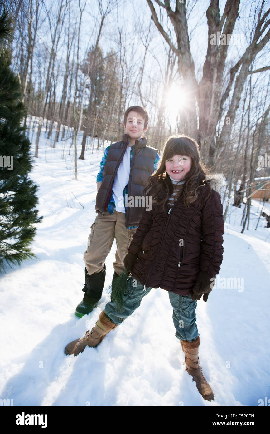 Brother and sister standing in snow, portrait Stock Photo - Alamy