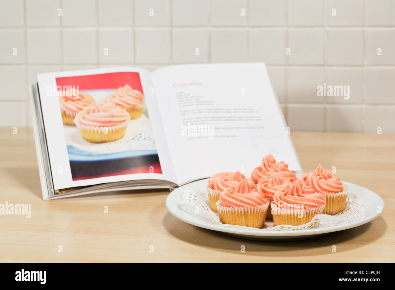 Cupcakes and cookery book Stock Photo