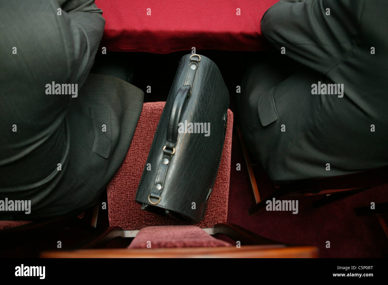 portfolio, situated between two people. Stock Photo