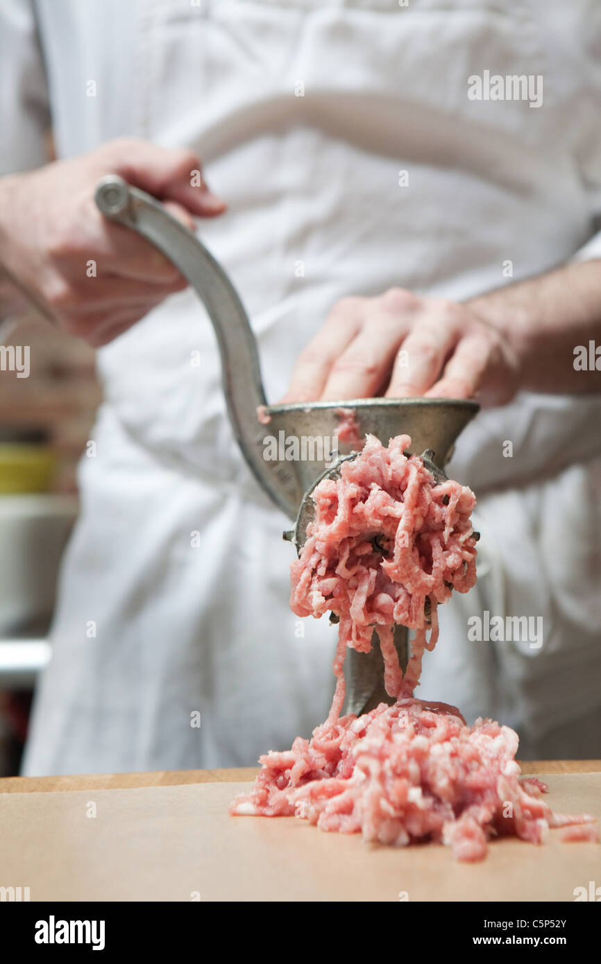 Butcher making mince Stock Photo