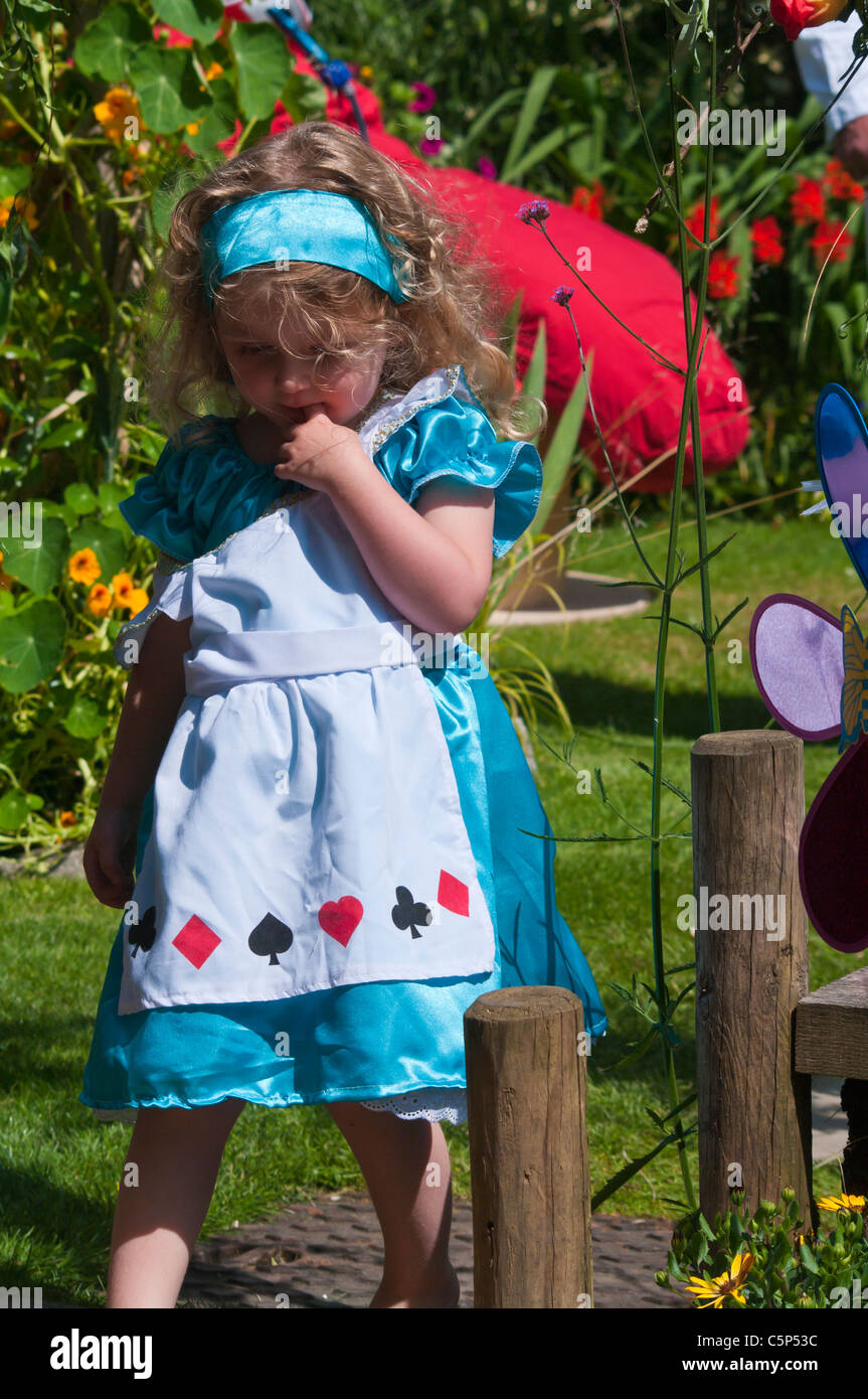 Little Girl Dressed In Alice In Wonderland Costume Stock Photo