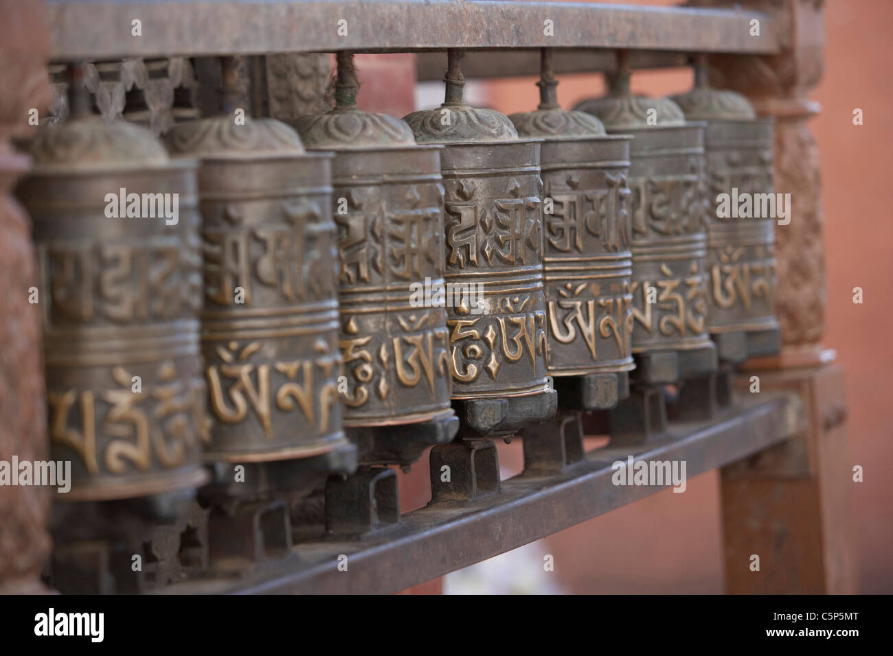 Tibetan Buddhist prayer wheels at the temple of Swayambhunath or monkey ...