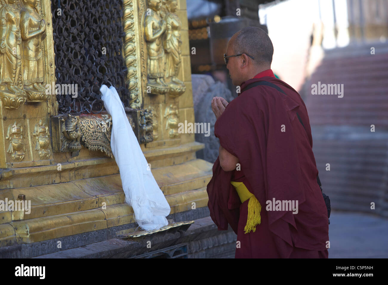 Buddhist monk praying at the temple of Swayambhunath or monkey temple ...
