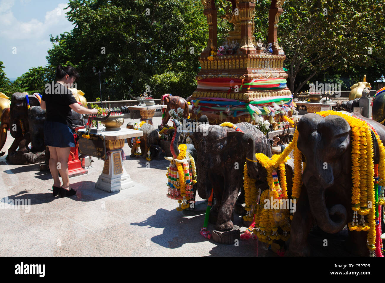 Thai Buddhist praying at open air Buddhist temple devoted to sacred elephants at Cape Promthep. Stock Photo