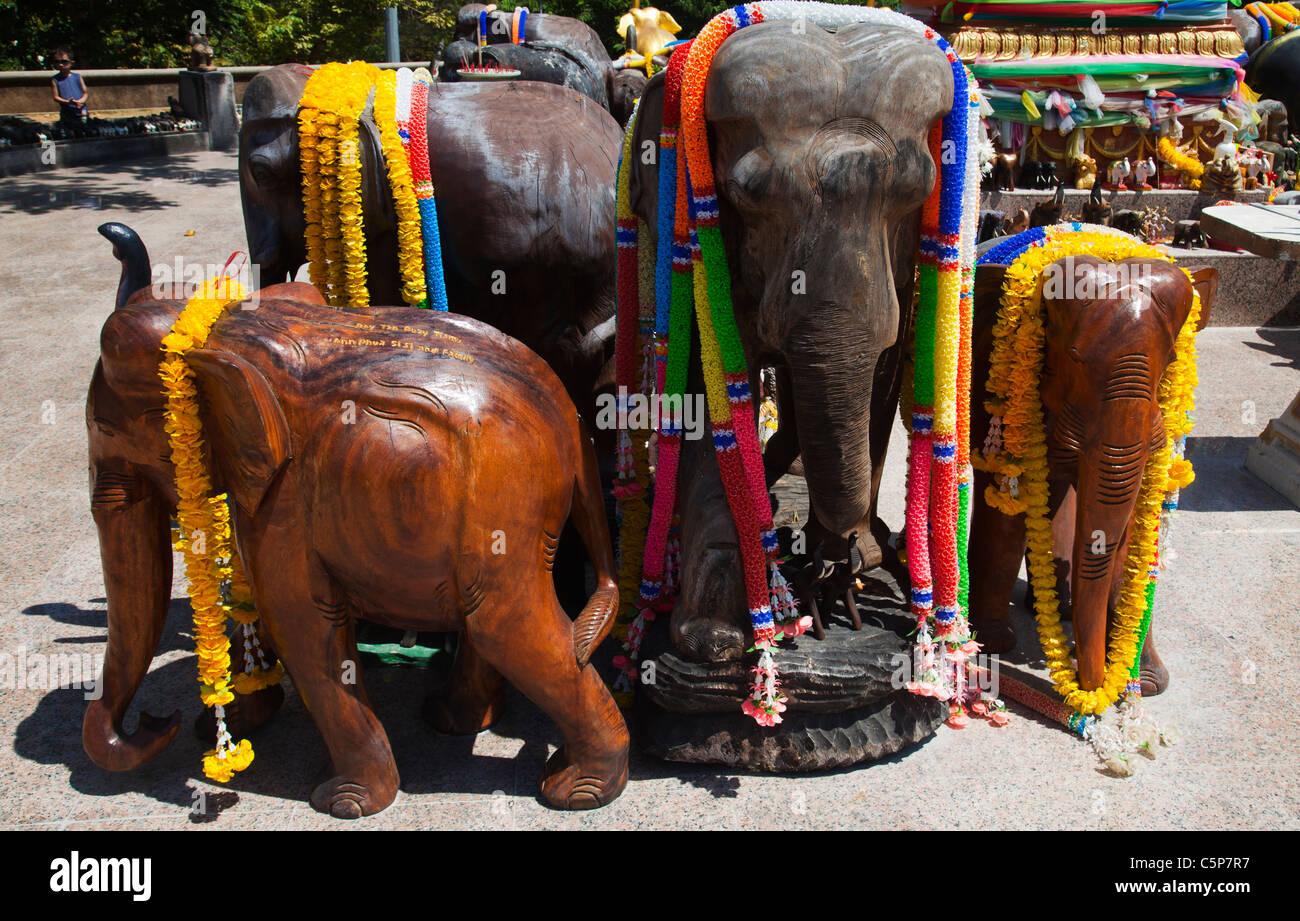 Wood carved elephants at Thai Buddhist Buddhist temple devoted to sacred elephants at Cape Promthep. Stock Photo