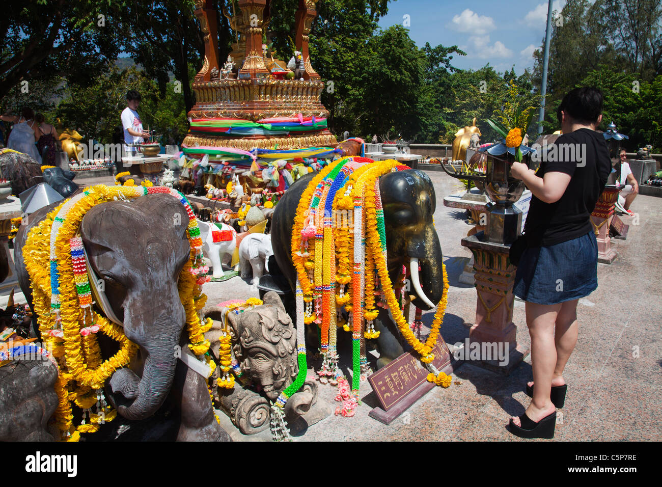 Thai Buddhists praying at open air Buddhist temple devoted to sacred elephants at Cape Promthep. Stock Photo