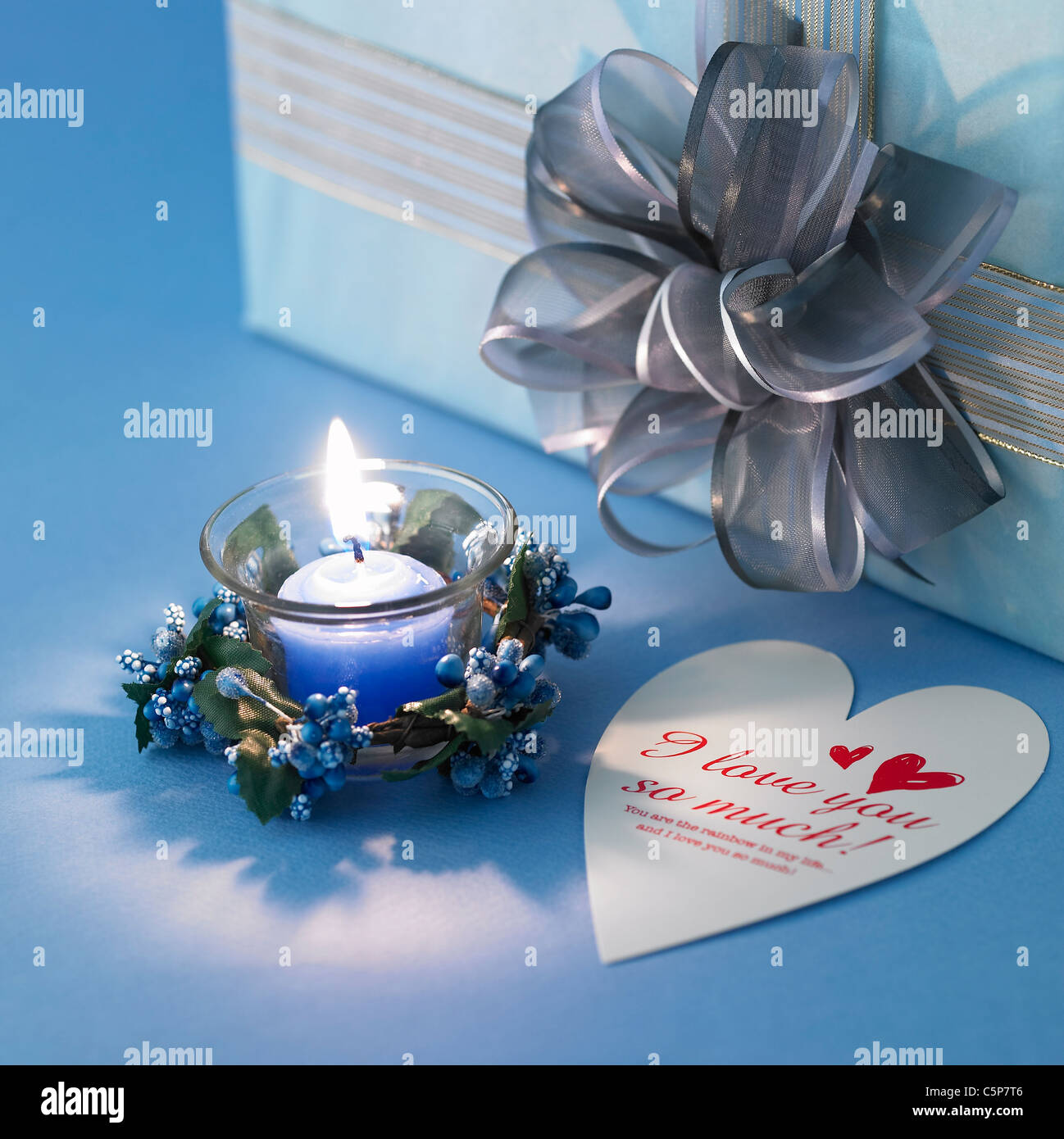 A candle light and a present Stock Photo Alamy