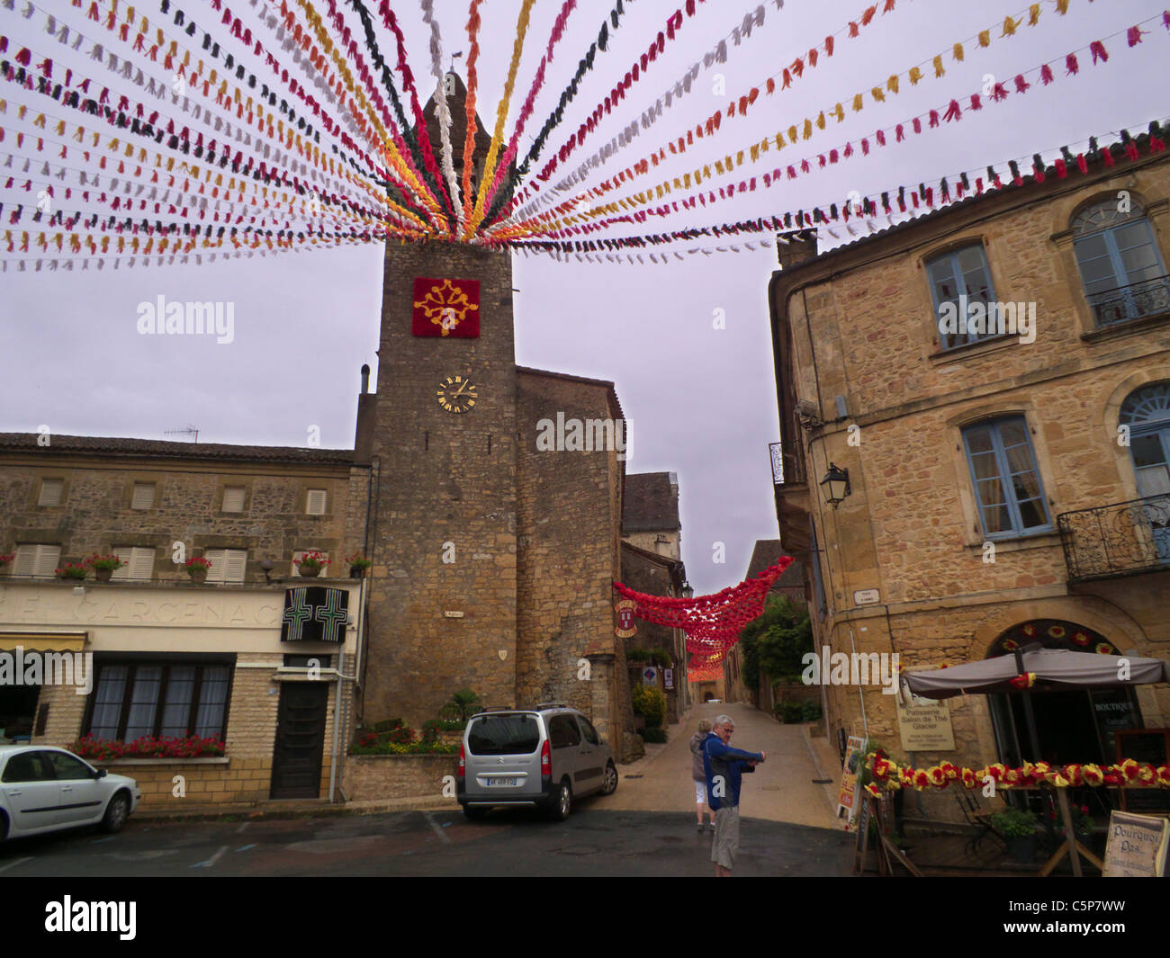 Belves town. Dordogne France. Lively medieval town. Decorations stream over the market square. Stock Photo
