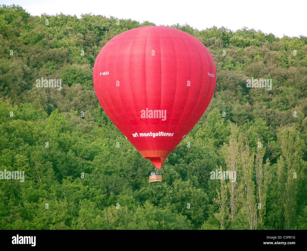 Hot air ballooning over Les Milandes village. St Cyprien. Dordogne France Stock Photo