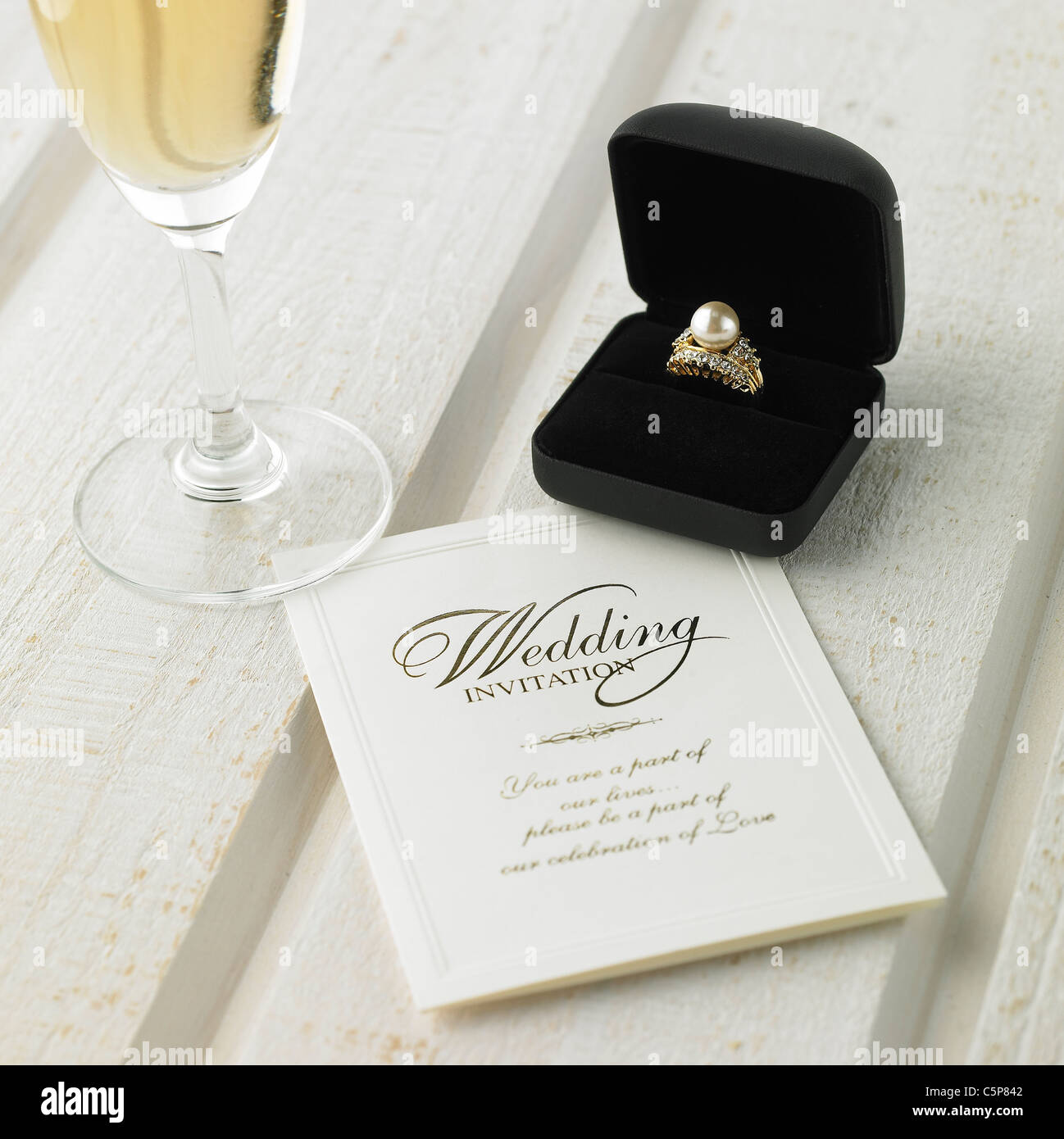 Wedding invitation and a wedding ring Stock Photo