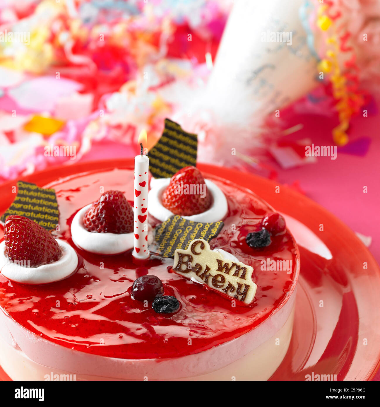 A cake with a candle on Stock Photo Alamy