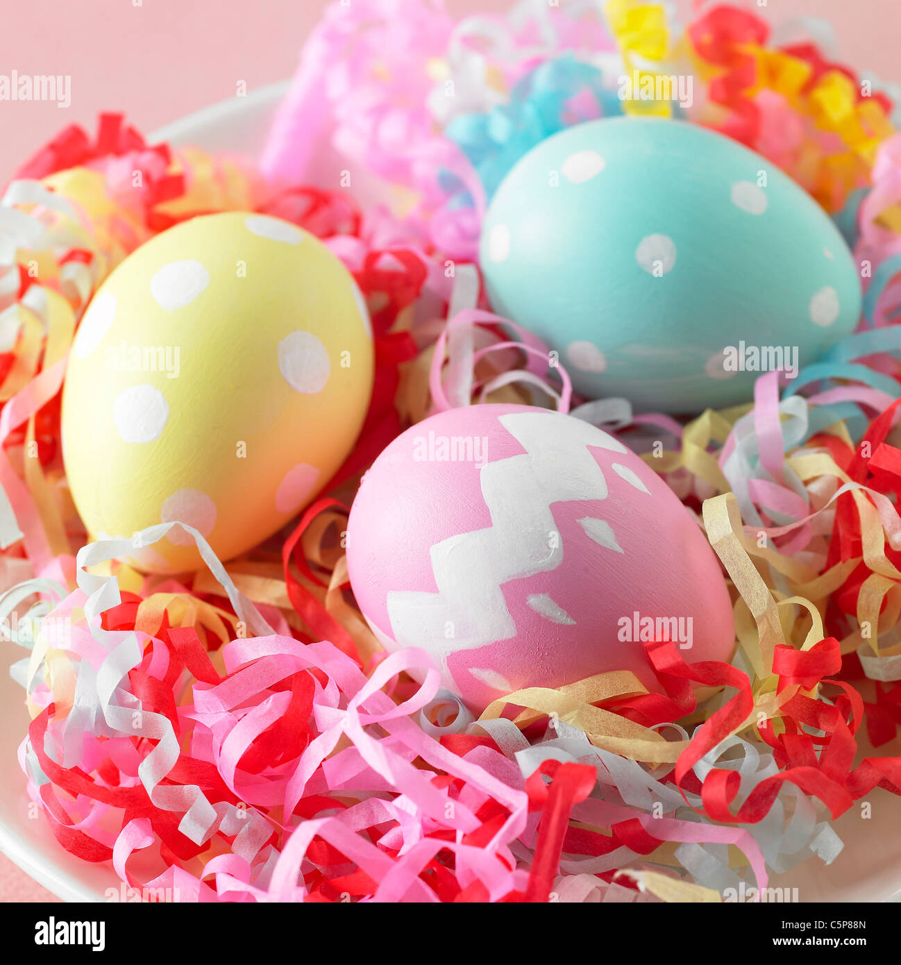 Painted eggs in the ribbons Stock Photo