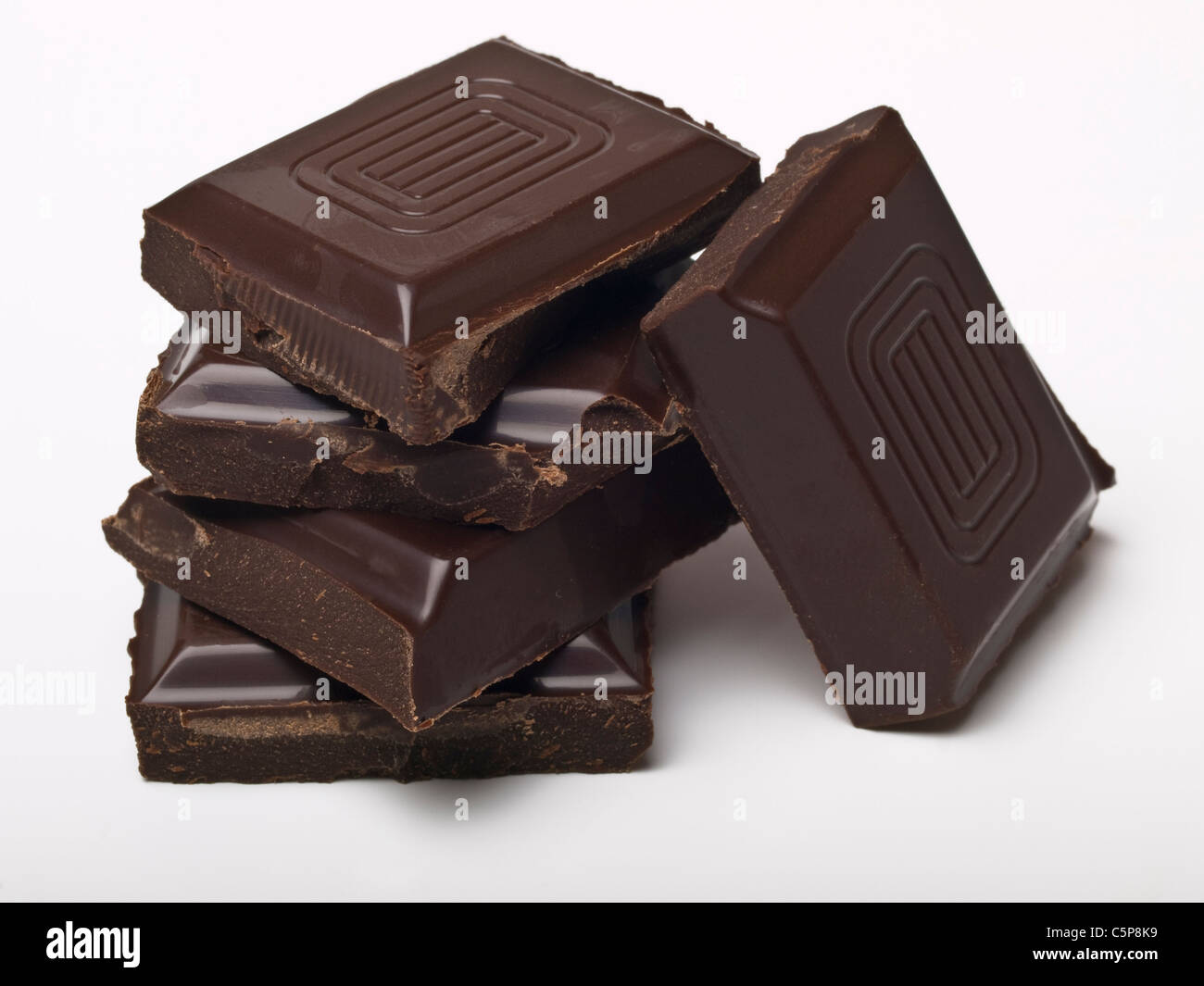 Detail photo of some pieces of dark chocolate lying upon each other Stock Photo