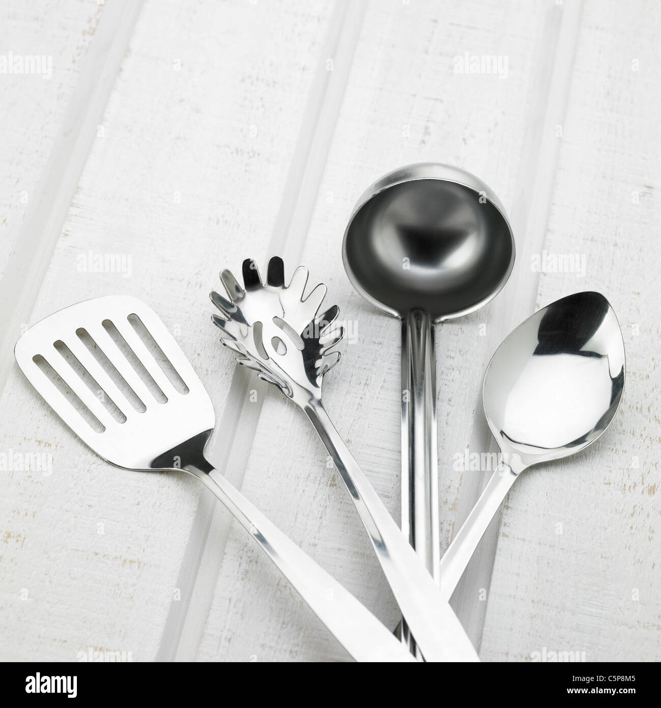 A turner, a pasta server, a ladle and a spoon Stock Photo