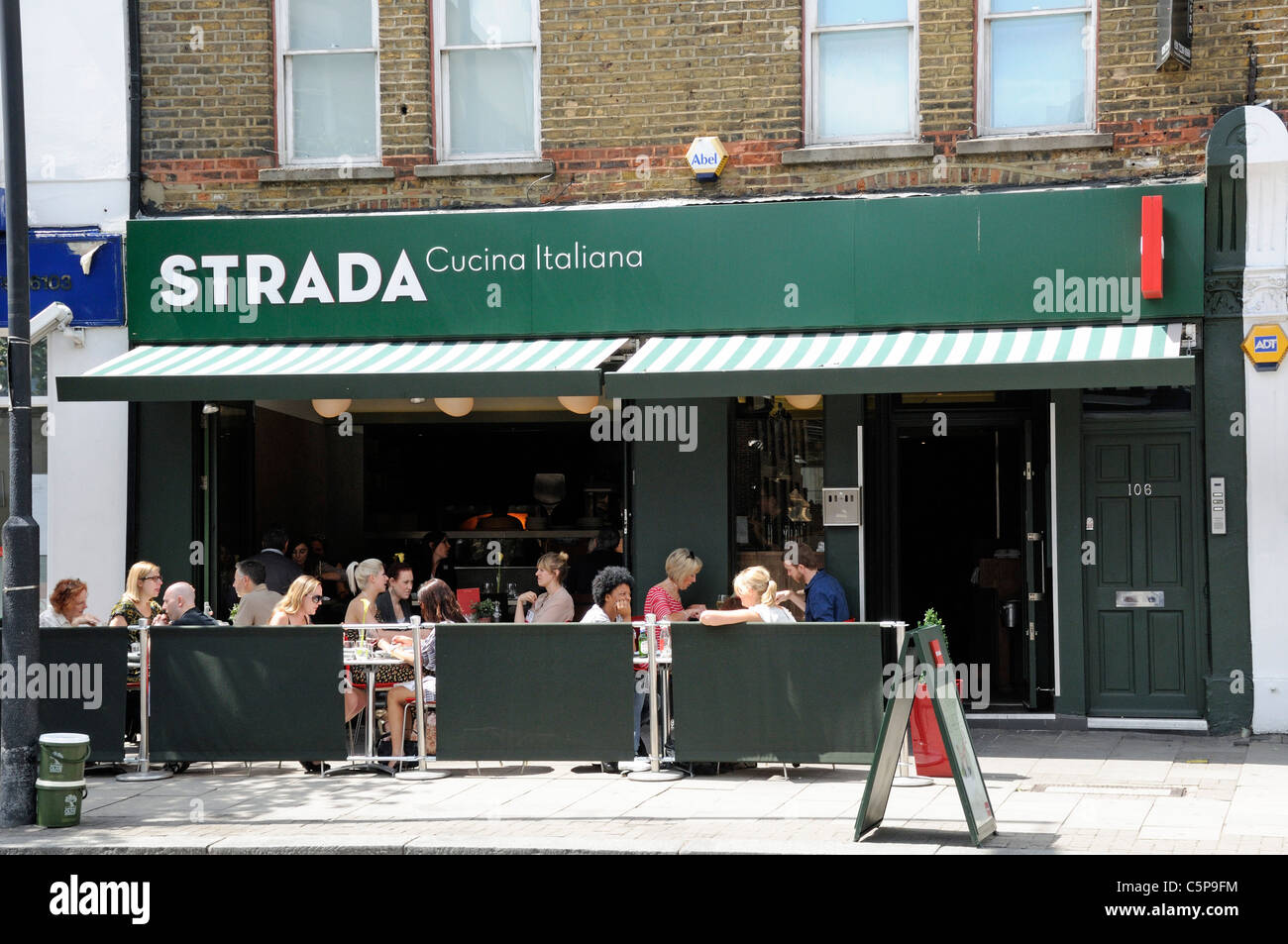 People enjoying a meal outside at Strada Restaurant Upper Street Islington London England UK Stock Photo