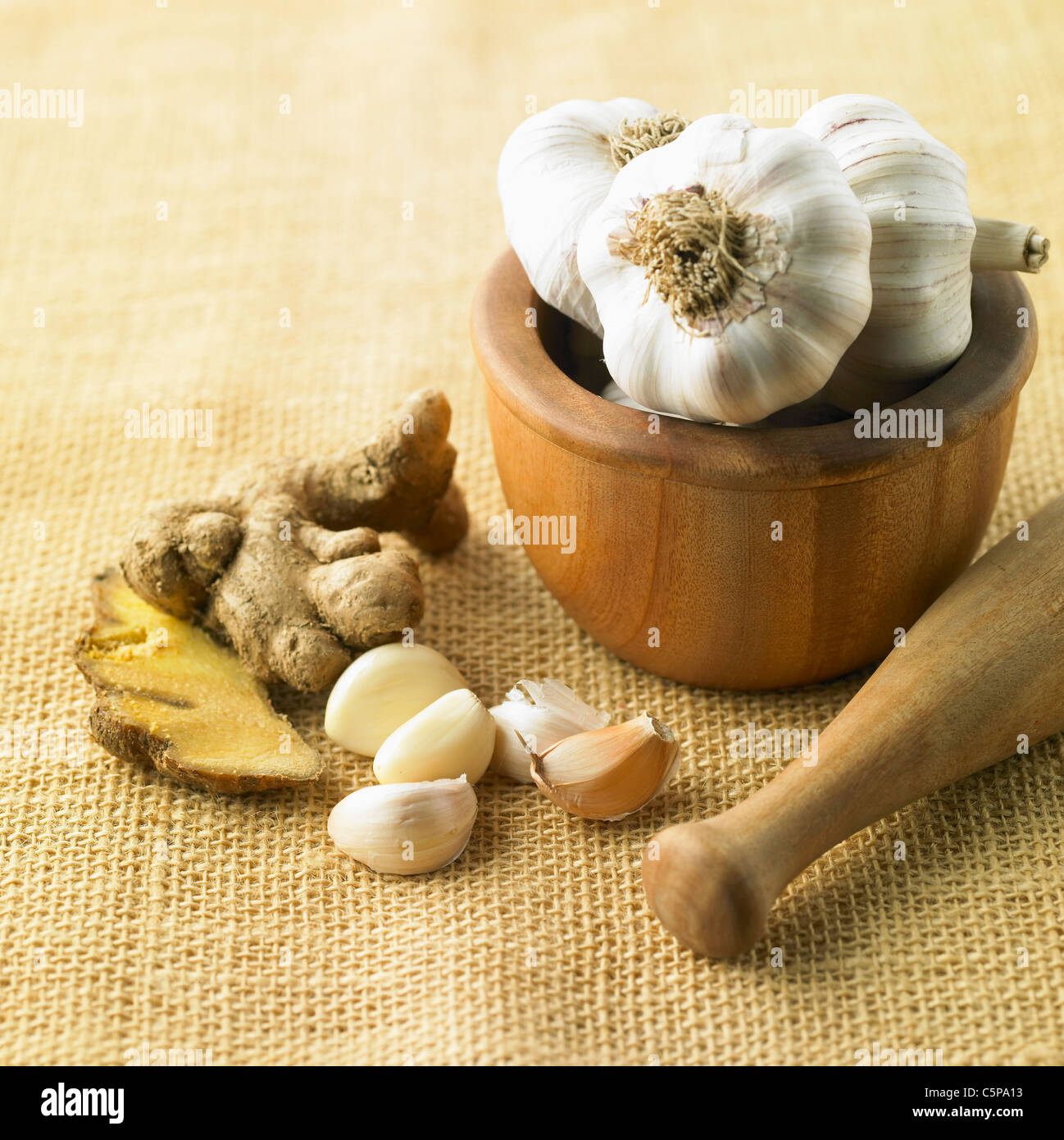 Garlic and gingers with mortar and pestle Stock Photo Alamy