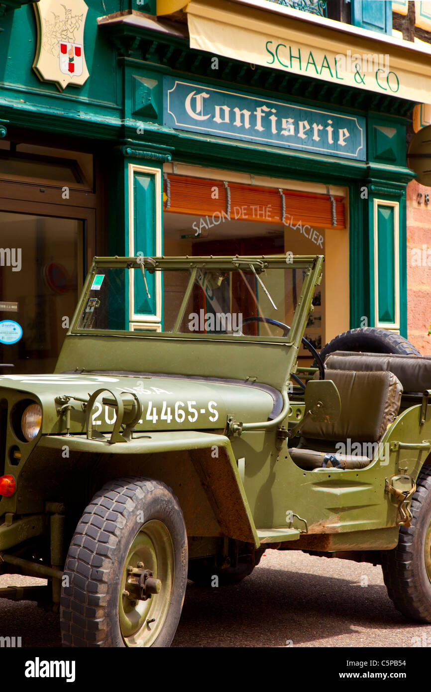 World War II US Army Jeep parked in front of a Tea shop in Ribeauville along the Wine Route, Alsace Haut-Rhin France Stock Photo