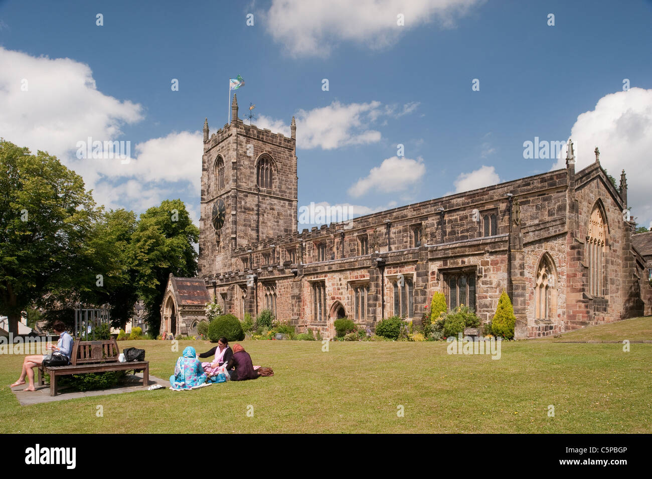 Holy Trinity Church, Skipton friends & family sitting, relaxing on sunny scenic churchyard