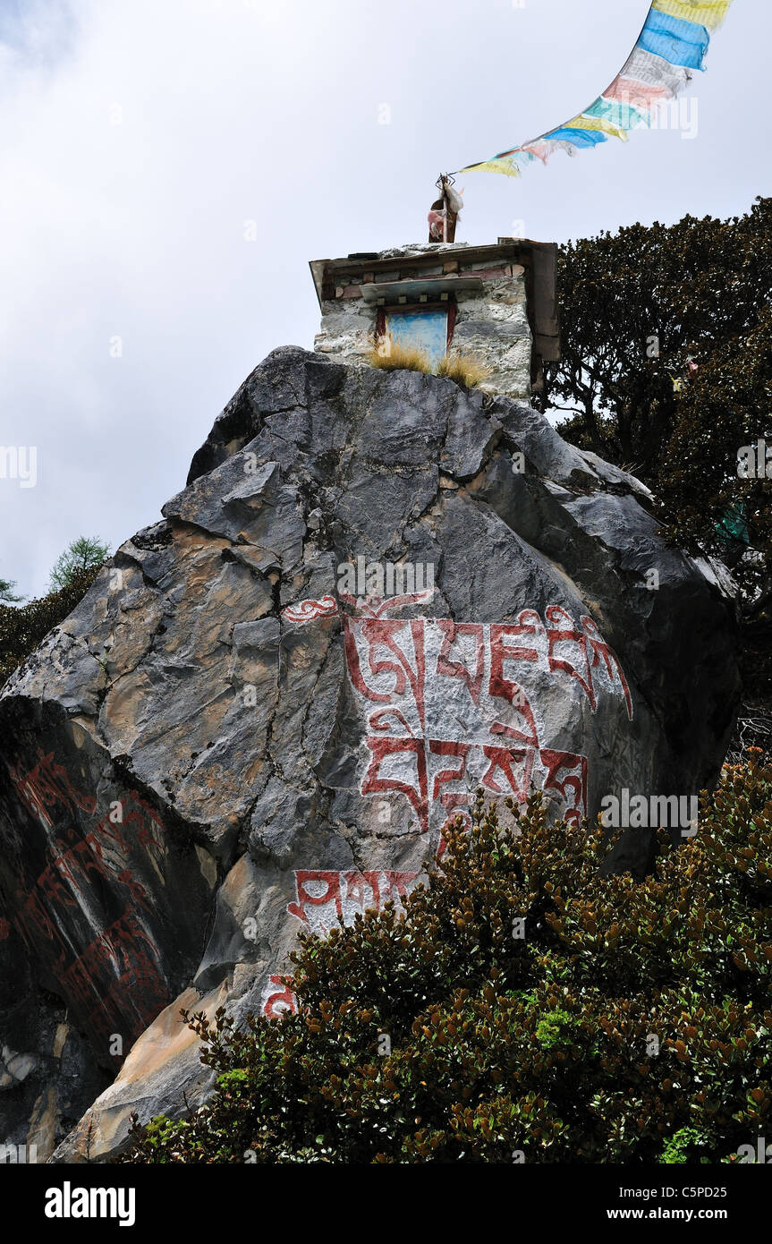 Tibetan Buddhism prayers painted on a rock wall Stock Photo Alamy