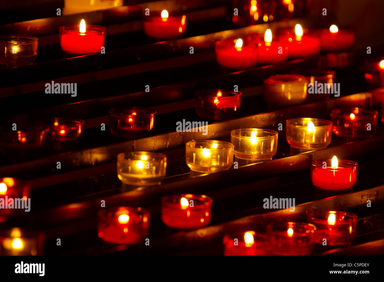 Prayer candles burning brightly in the Messina, Sicily Cathedral Stock