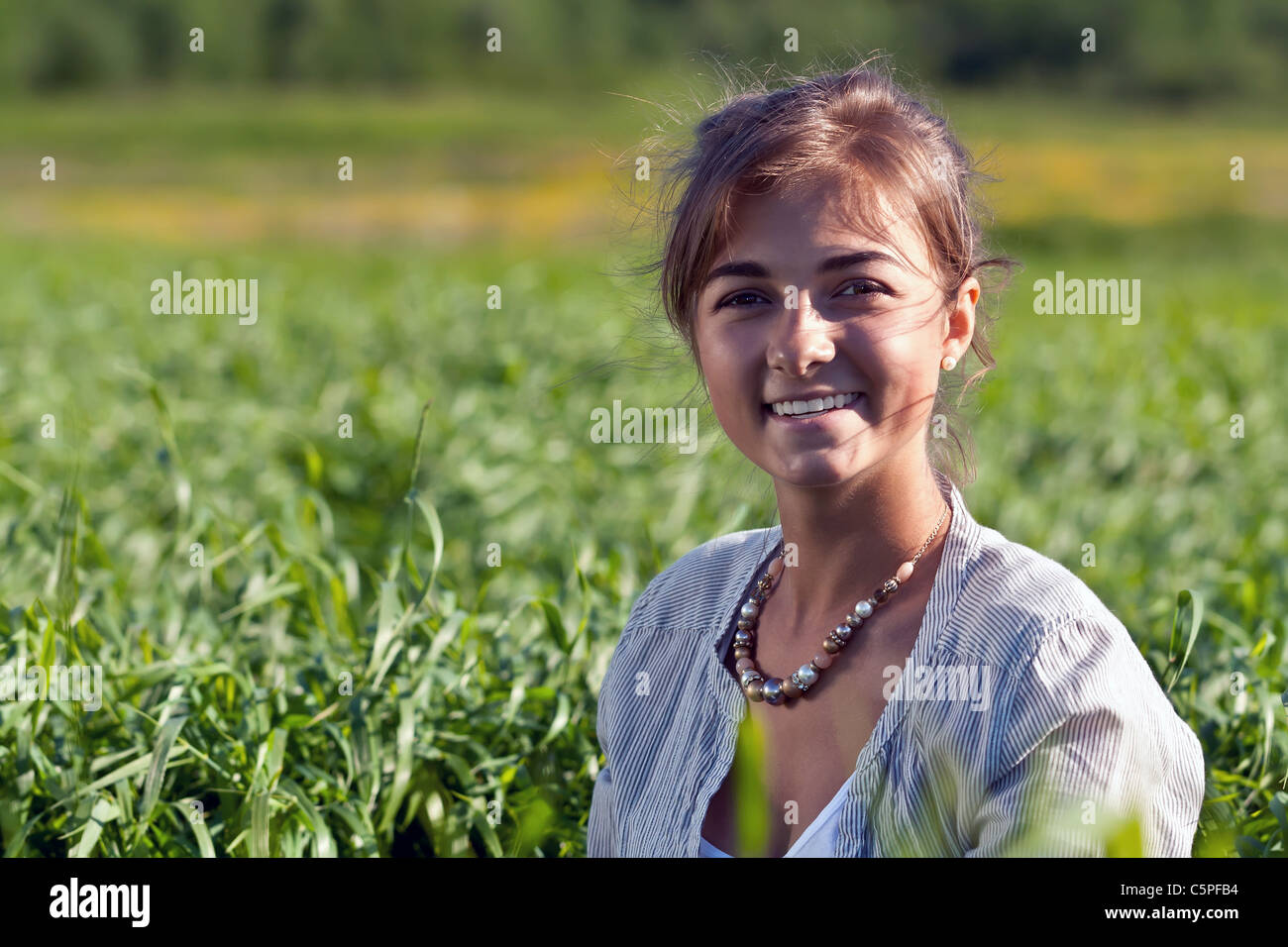 portrait of a beautiful girl in the green grass Stock Photo - Alamy