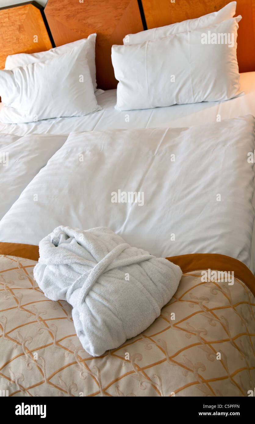White robe folded lie on the bed in hotel rooms Stock Photo Alamy