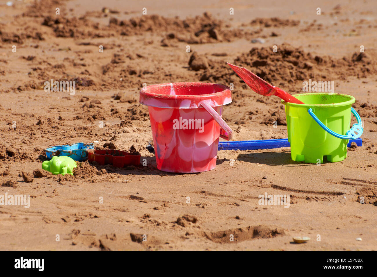 Plastic bucket and spade on a south Devon beach in England Stock Photo